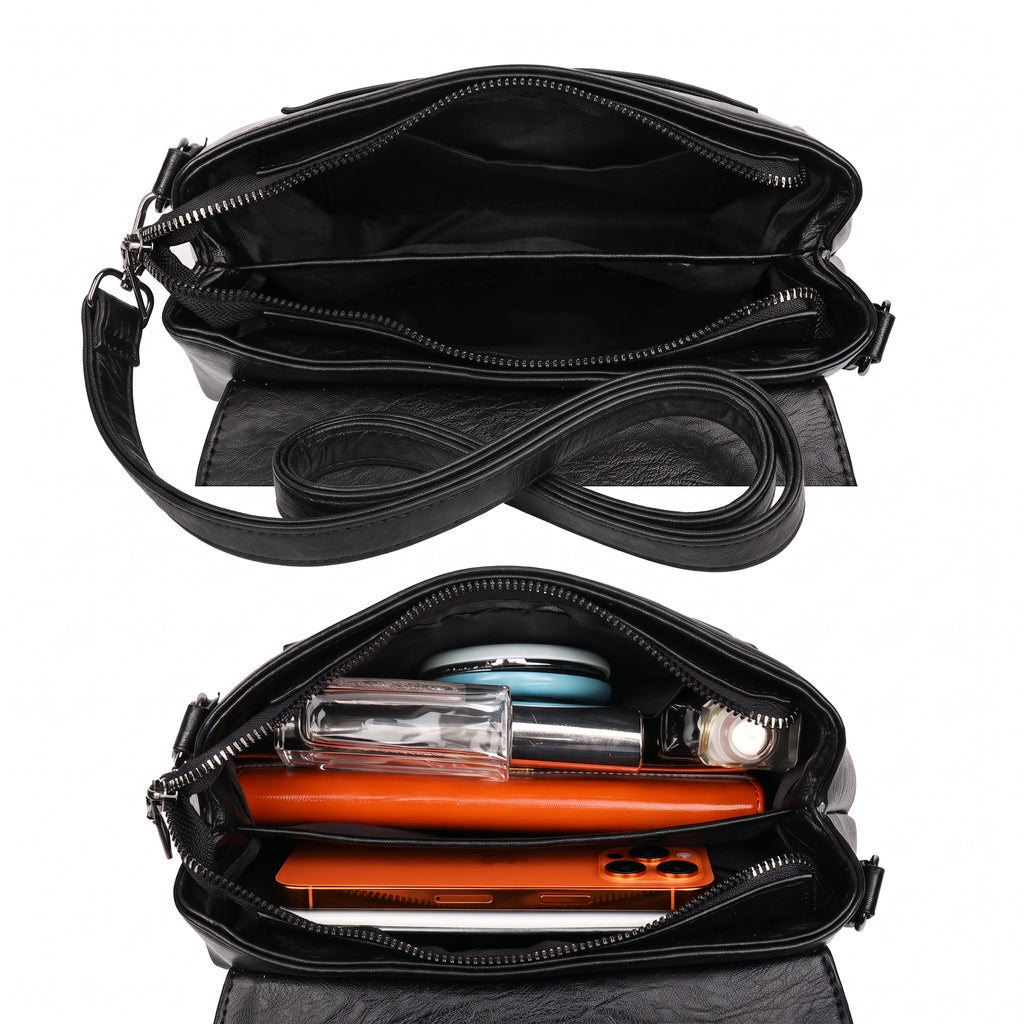 Bolsa clutch preta aberta mostrando os compartimentos internos, com celular, carteira e perfume