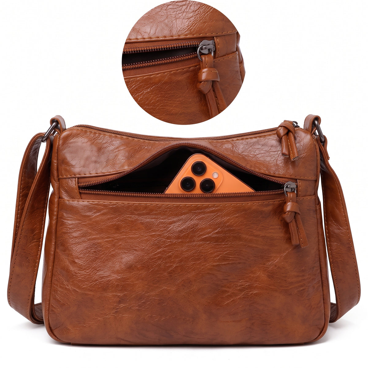 Bolso traseiro com zíper da bolsa crossbody caramelo guardando um celular