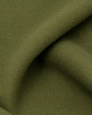 Textura da lã batida fosca e compacta do sobretudo verde